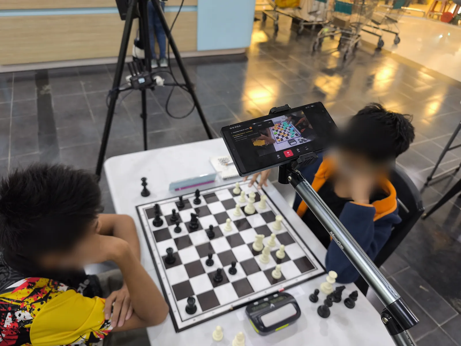 Phone on a boom arm above Table 1 running ChessZCam at Lotus's Kulim