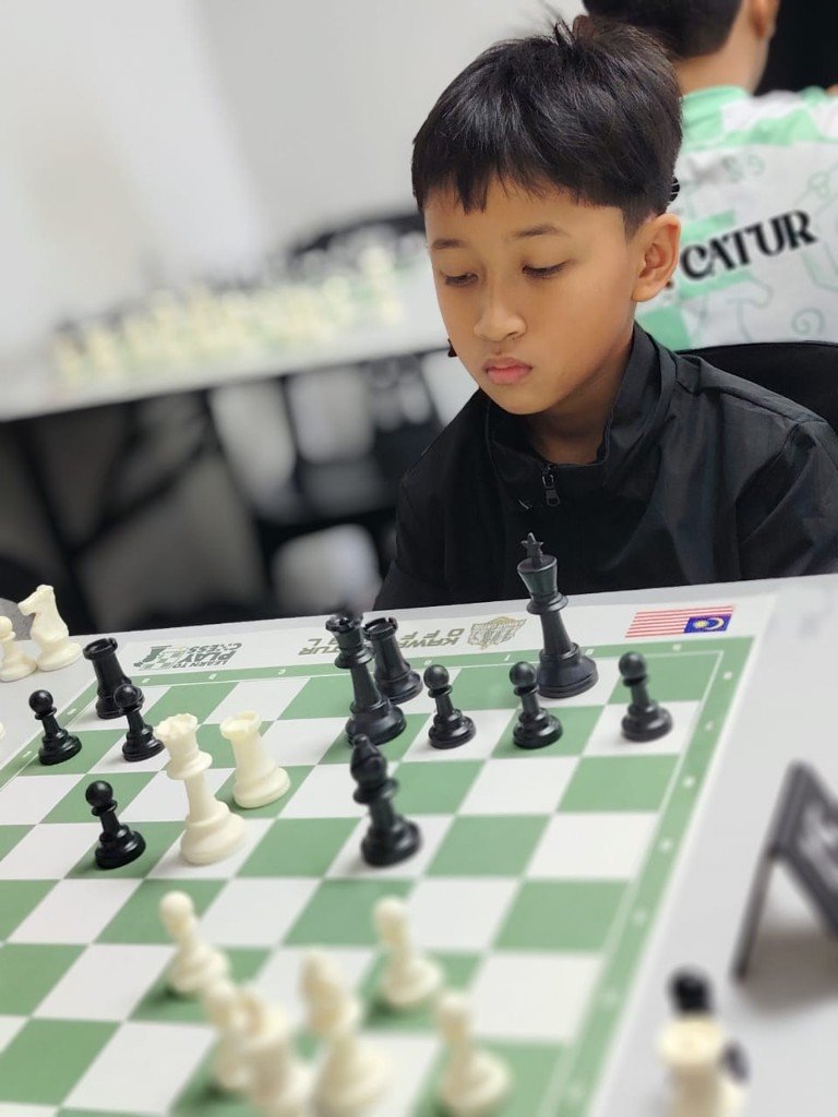 Junior chess player concentrating during an over-the-board tournament