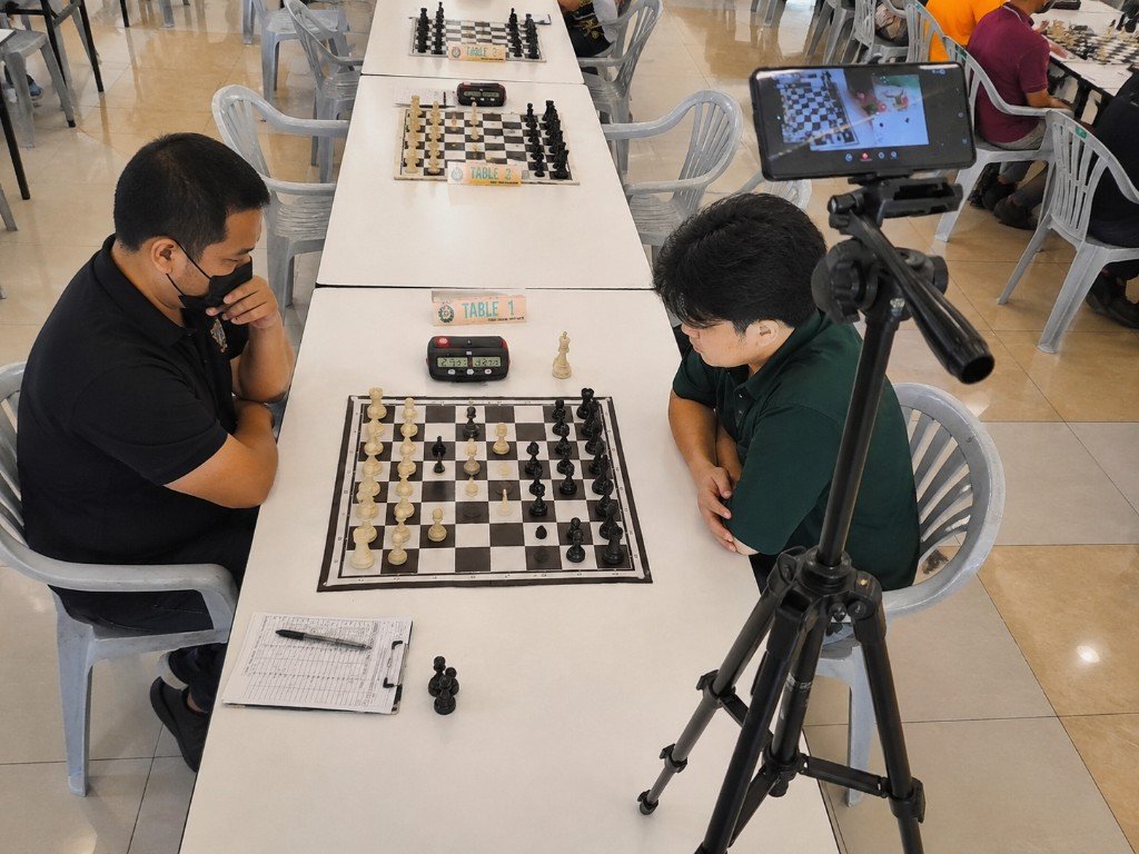 Phone on a tripod recording a featured tournament board